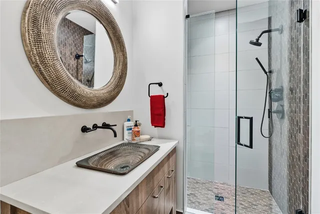 a bathroom with a sink a toilet and shower