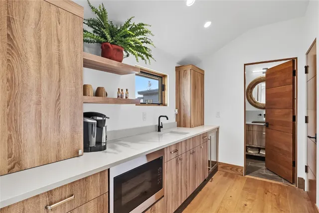 a kitchen with a refrigerator and a sink