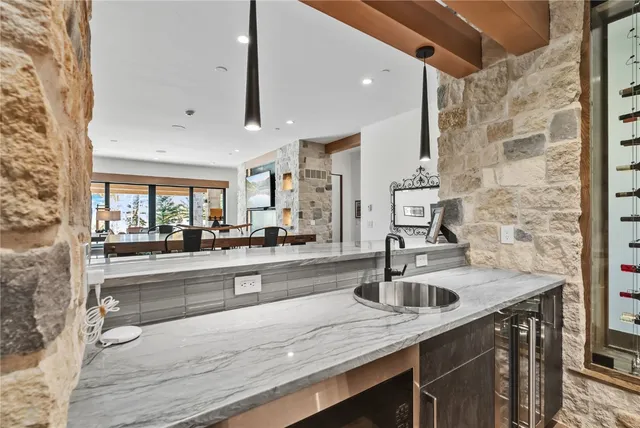 a kitchen with stainless steel appliances granite countertop a sink and a refrigerator