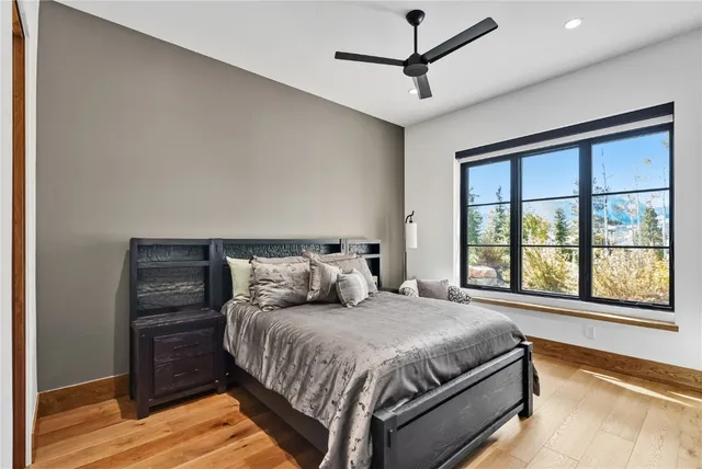 a bedroom with a large bed and a window