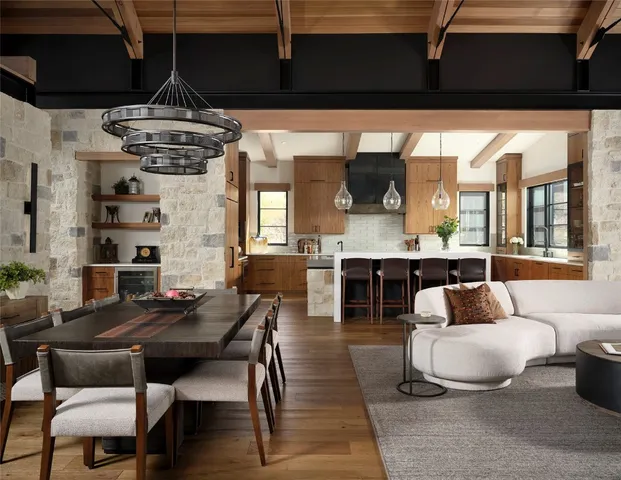 a living room with stainless steel appliances kitchen island granite countertop furniture and a kitchen view