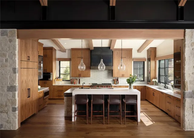 a large kitchen with a table and chairs