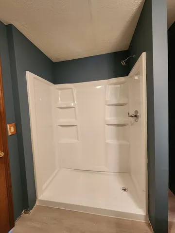 a view of a house with wooden floor and wooden fence