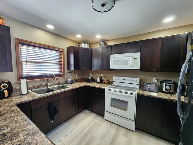 a kitchen with stainless steel appliances granite countertop a sink stove and oven
