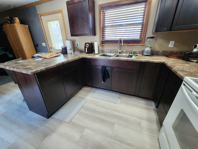 a kitchen with a sink stove and cabinets
