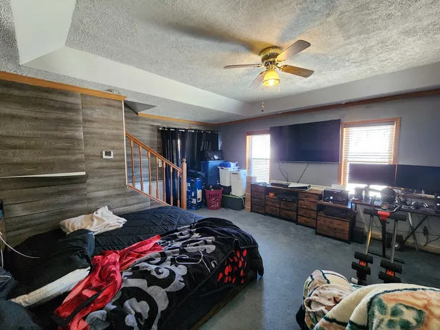 a bedroom with bed and a chandelier