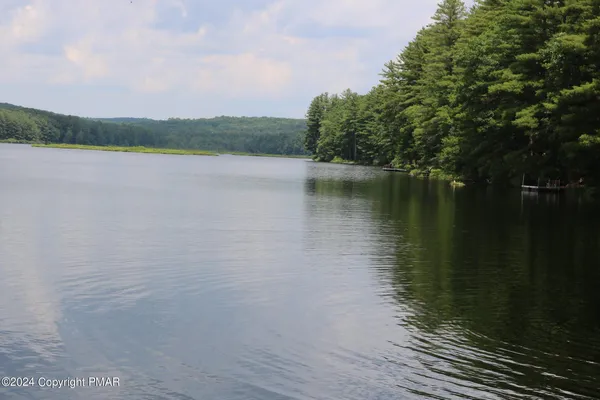a view of an house with backyard outdoor seating and hardwood