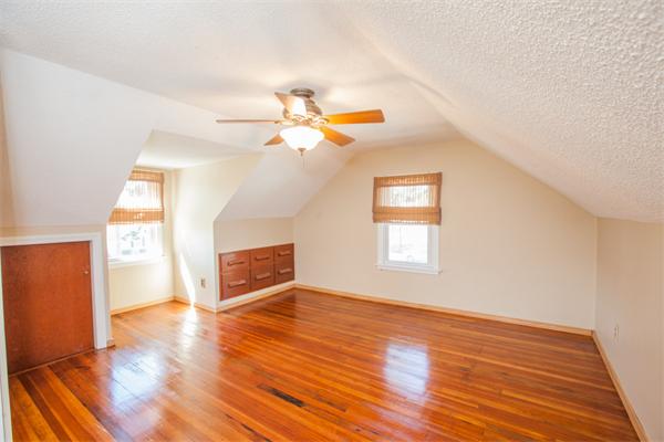 113 Old Brook Road Springfield, MA 01118 - Photo 26 of 30 an empty room with wooden floor chandelier fan and windows