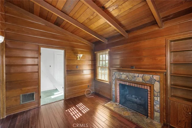 a view of a room that has a bed and a table in it