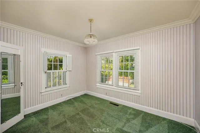a view of entryway with a window and a ceiling fan