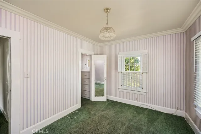 a view of a house with backyard and trees