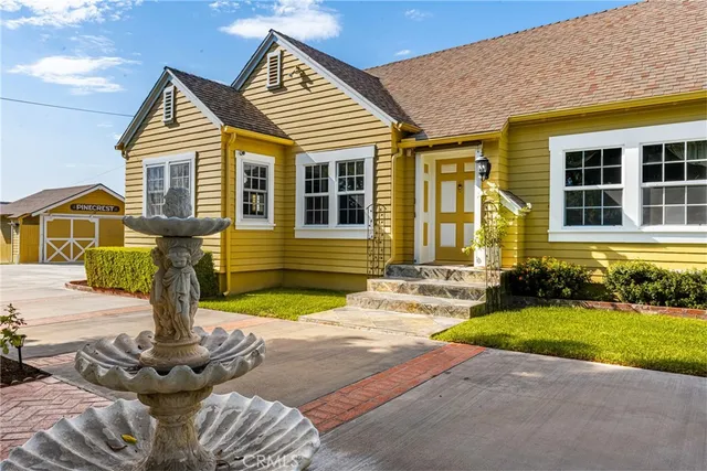 a front view of a house with garden and patio