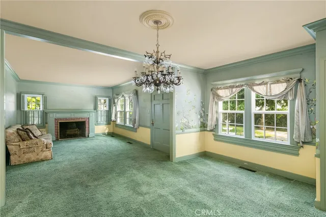 a view of a livingroom with a fireplace and window