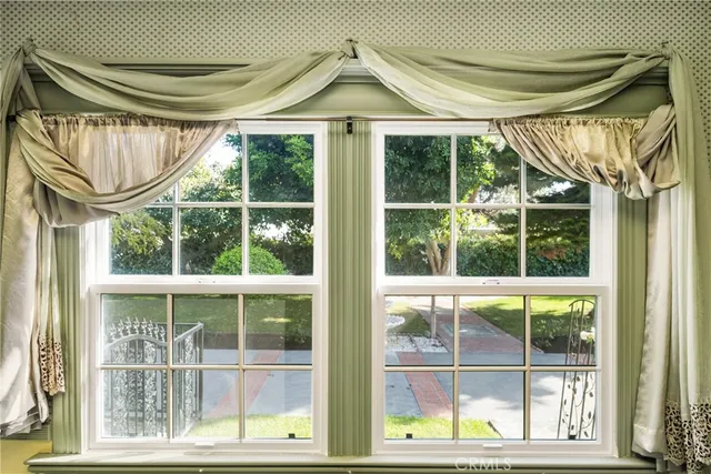 a view of a big room with windows and chandelier