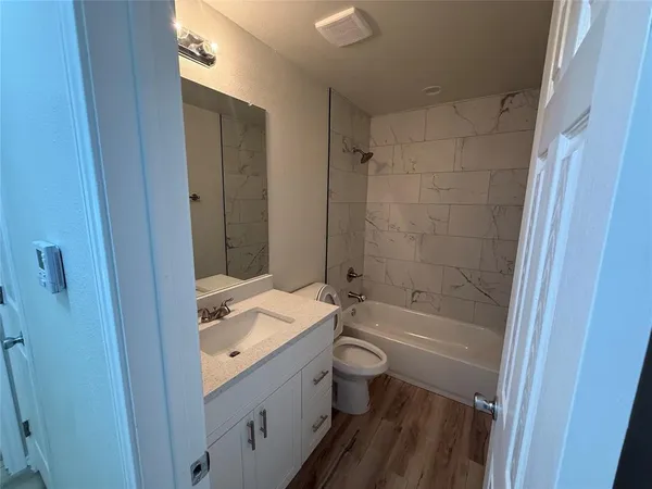 a bathroom with a sink a toilet and bathtub