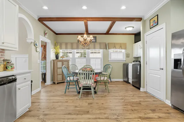 a bathroom with a bathtub a window and a shower