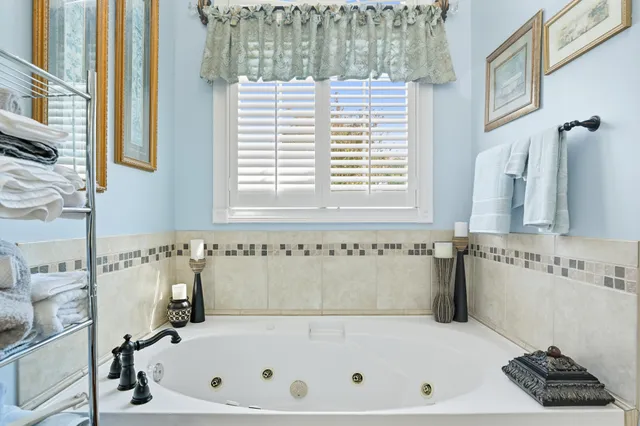 a kitchen with stainless steel appliances a sink window and cabinets