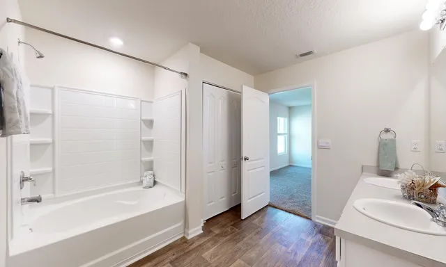 a bathroom with a bathtub and a sink