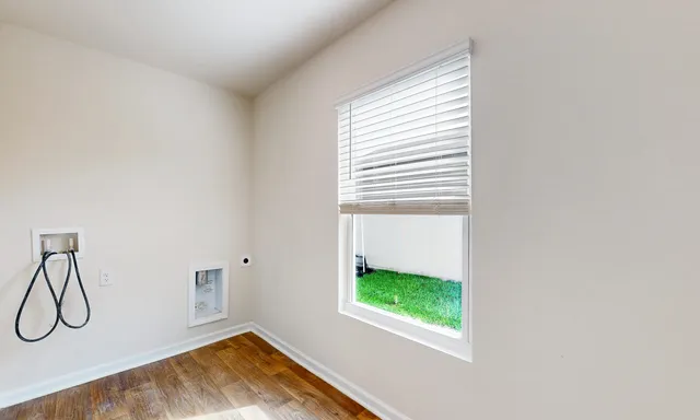 a view of a room that has a window and a fan