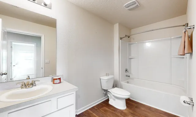a bathroom with a sink toilet and shower