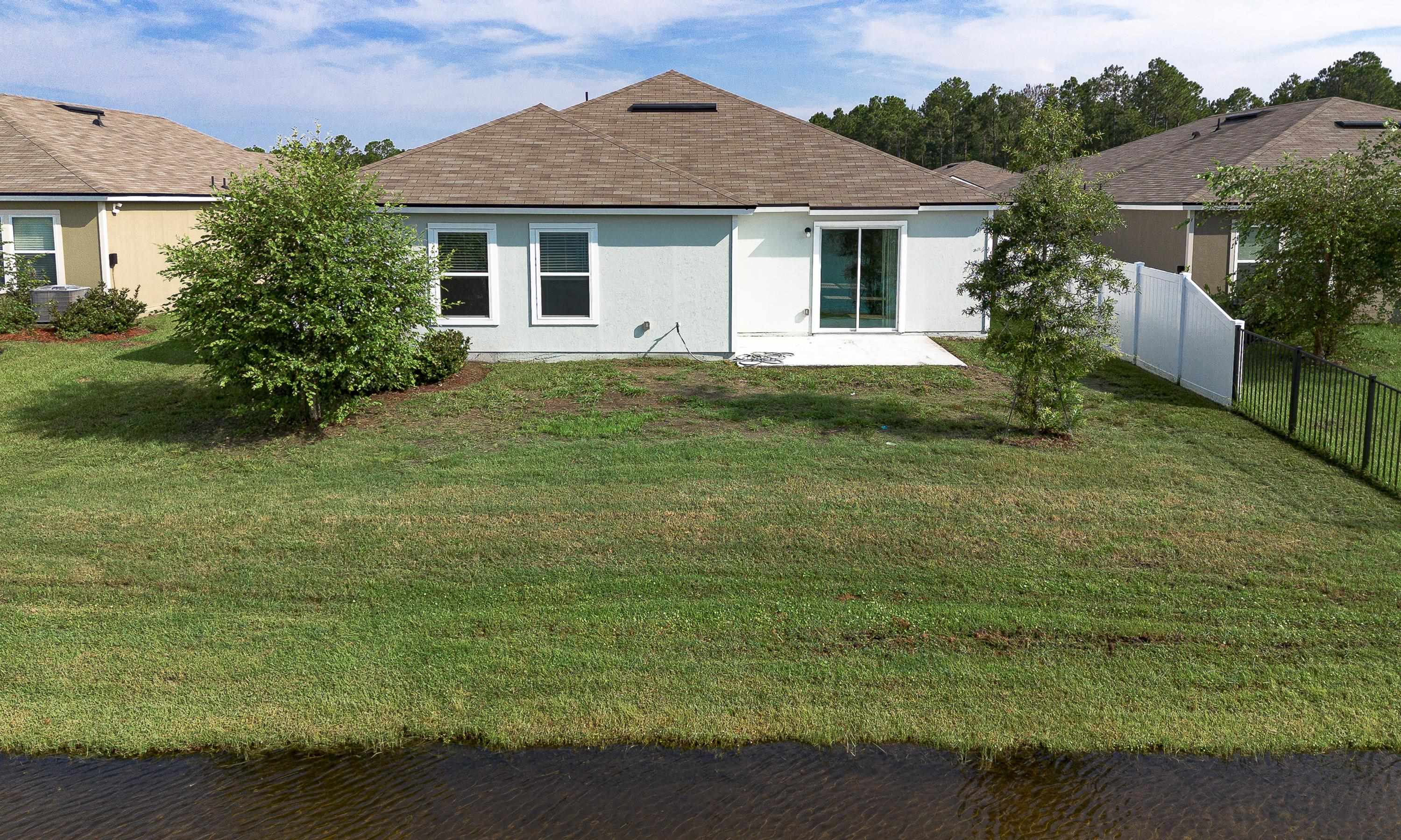 233 Falcon Ridge Road St. Augustine, FL 32084 - Photo 33 of 41 a front view of a house with garden