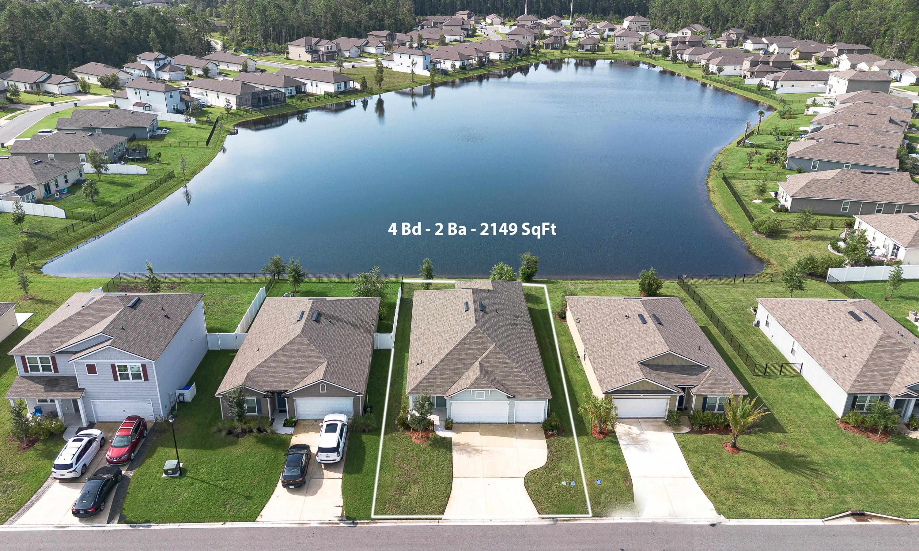 233 Falcon Ridge Road St. Augustine, FL 32084 - Photo 34 of 41 an aerial view of residential houses with outdoor space and lake view