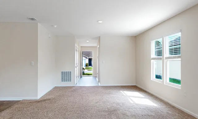 an empty room with windows and entrance