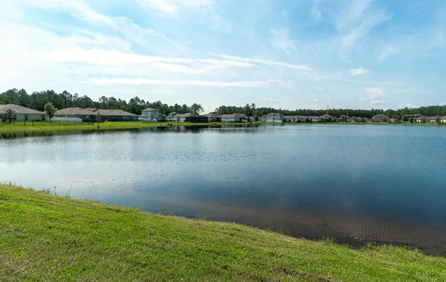 a view of a lake with houses in the back