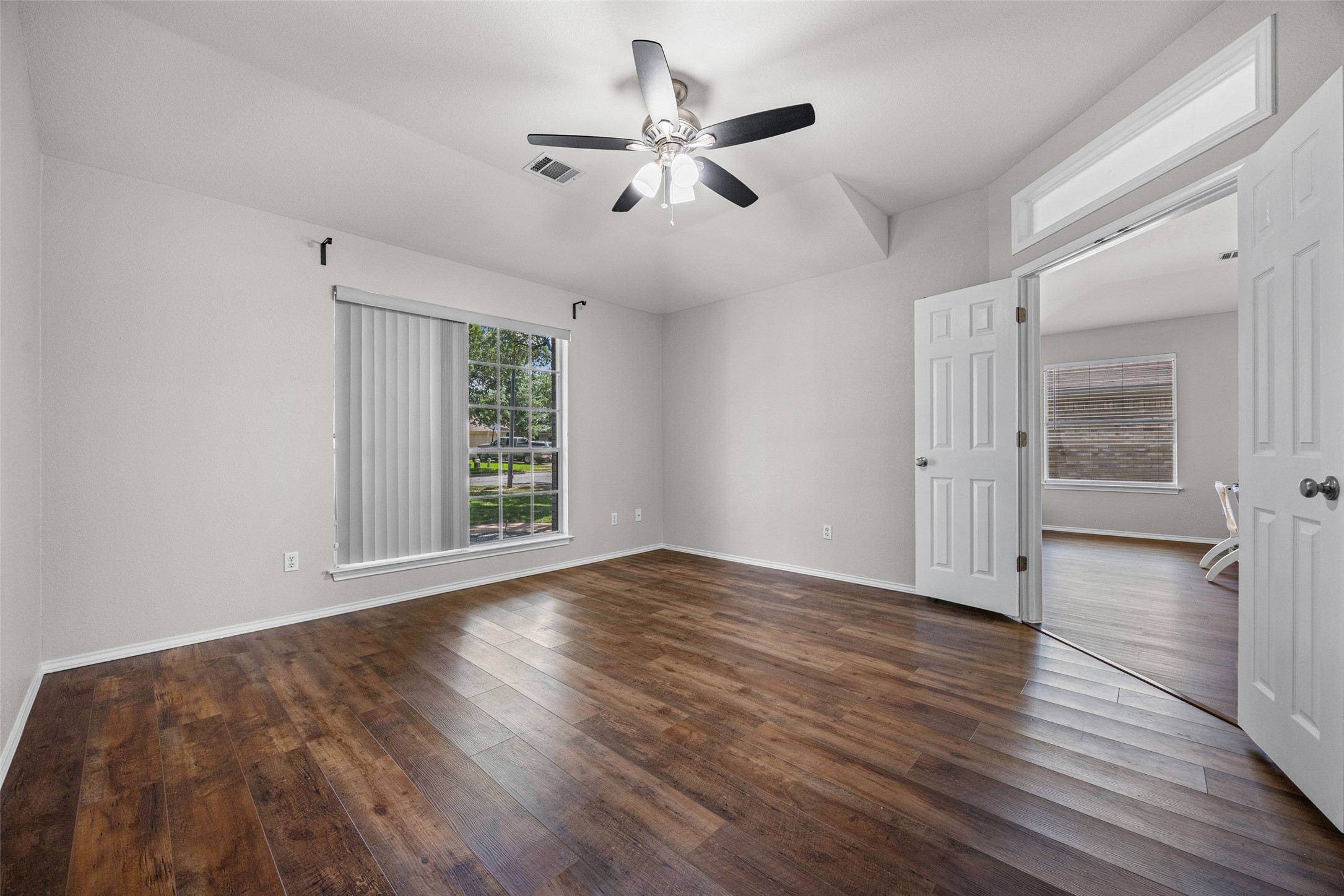 1524 Lochaline Loop Pflugerville, TX 78660 - Photo 19 of 22 Rich hardwood-style flooring extends across this spacious room, ready for your personalized touch.