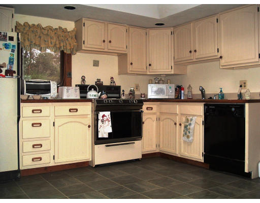 59 Middle Road Amesbury, MA 01913 - Photo 8 of 11 a kitchen with stainless steel appliances granite countertop a stove a sink and white cabinets