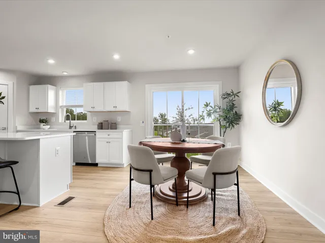 a view of a dining room with furniture and a mirror
