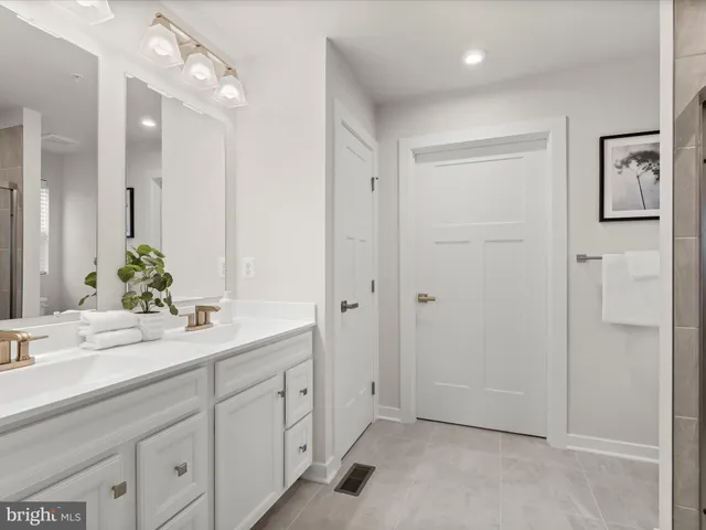 a bathroom with a glass shower door