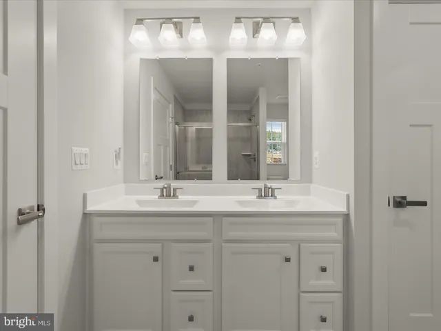 a bathroom with a double vanity sink and mirror