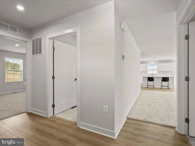 a living room with furniture a large window and a table