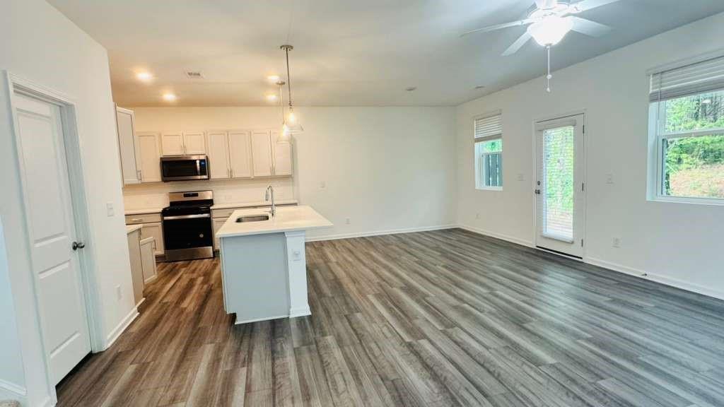 4078 Haleston Road Duluth, GA 30097 - Photo 3 of 25 a kitchen with a sink cabinets stainless steel appliances and a window