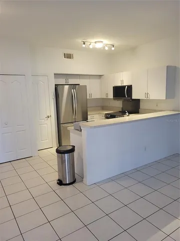a kitchen with a sink and a refrigerator