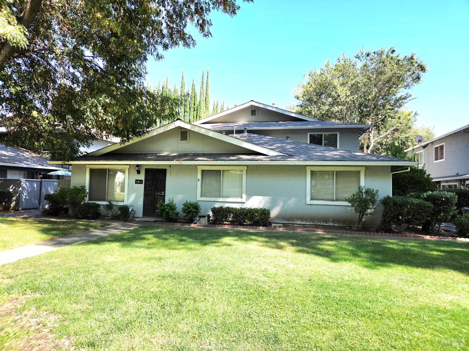 140 Del Rio Court, Unit 4 Vacaville, CA 95687 - Photo 1 of 25 a front view of a house with a yard outdoor and sitting area