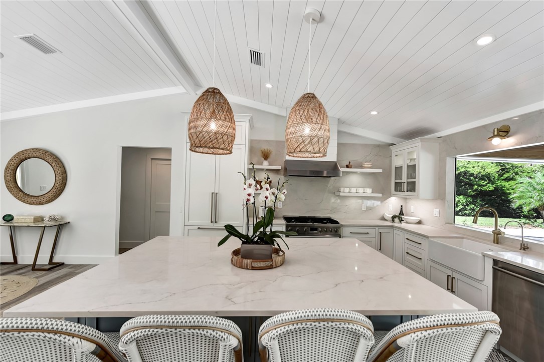 525 Banyan Road Vero Beach, FL 32963 - Photo 13 of 36 a kitchen with a table chairs a stove and a window