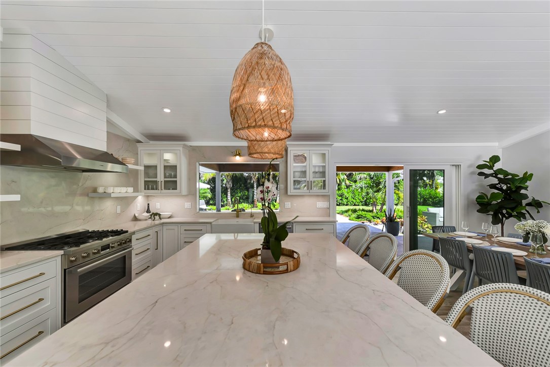 525 Banyan Road Vero Beach, FL 32963 - Photo 18 of 36 a kitchen with sink large window and stainless steel appliances