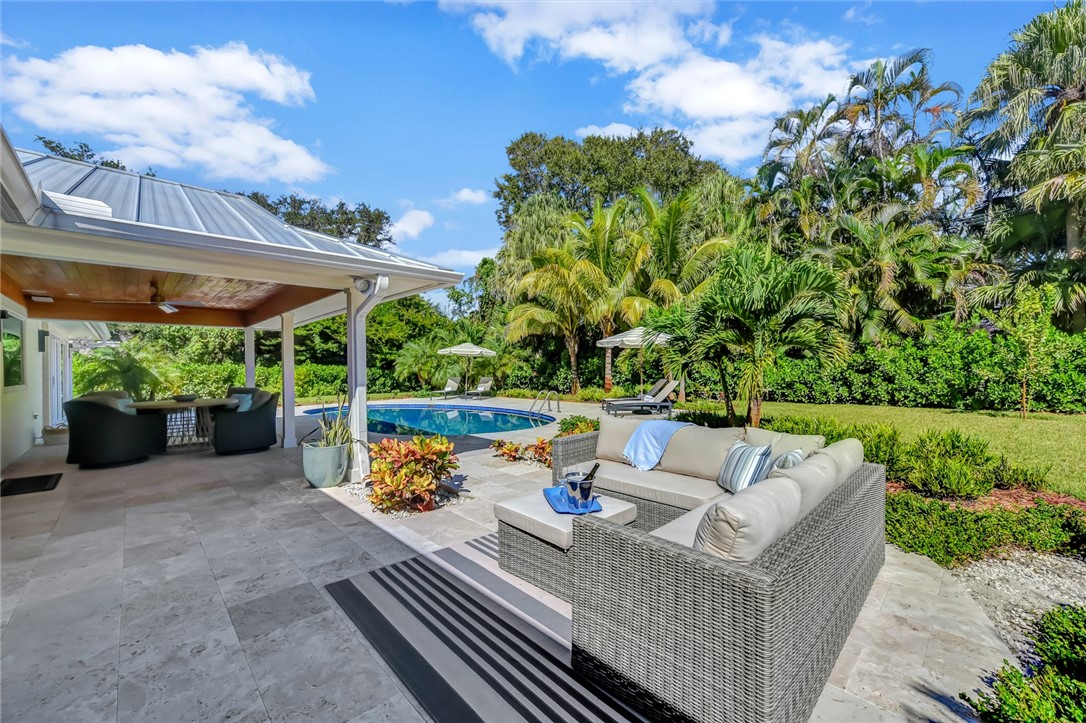 525 Banyan Road Vero Beach, FL 32963 - Photo 27 of 36 a view of a patio with couches table and chairs and potted plants