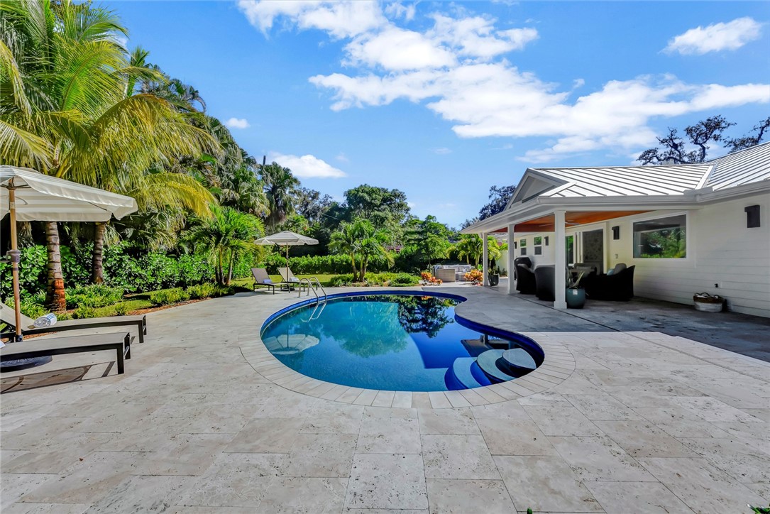 525 Banyan Road Vero Beach, FL 32963 - Photo 29 of 36 a swimming pool with outdoor seating and yard