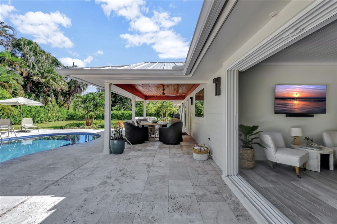 525 Banyan Road Vero Beach, FL 32963 - Photo 31 of 36 a view of a patio with a table and chairs under an umbrella