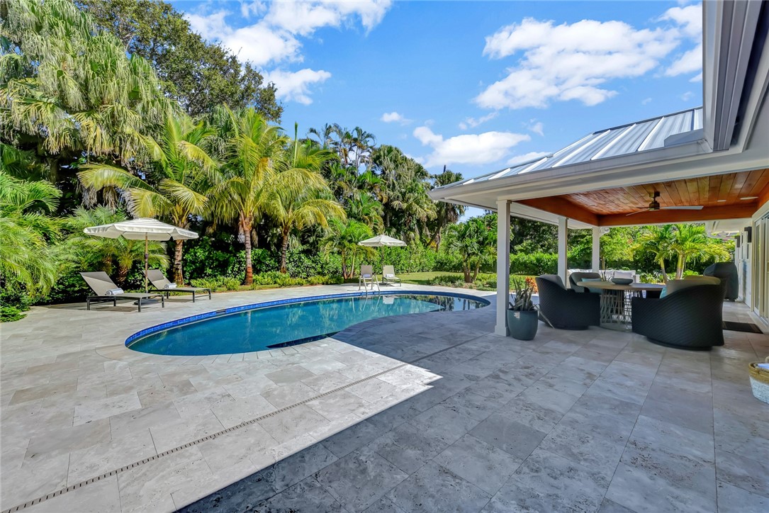 525 Banyan Road Vero Beach, FL 32963 - Photo 32 of 36 a view of a patio with a table and chairs under an umbrella