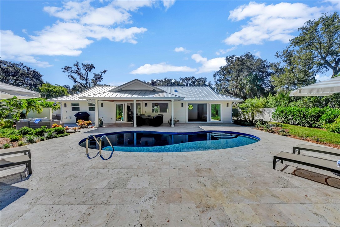 525 Banyan Road Vero Beach, FL 32963 - Photo 5 of 36 an outdoor sitting area with swimming pool and furniture