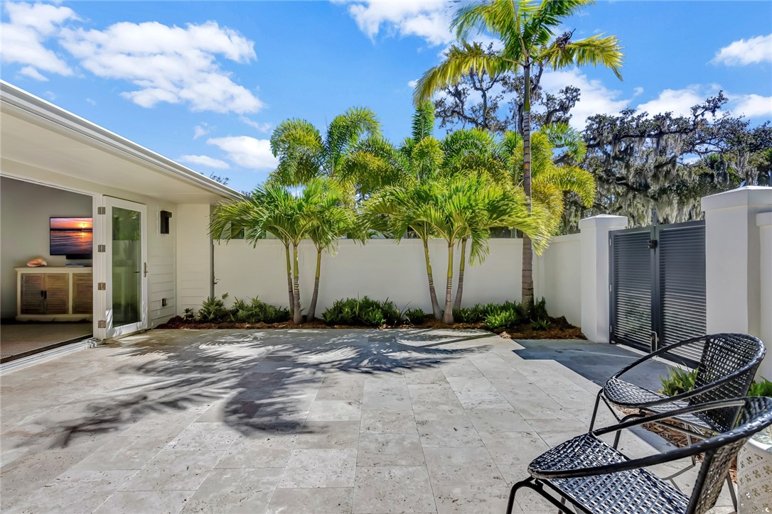 525 Banyan Road Vero Beach, FL 32963 - Photo 7 of 36 a row of palm trees in front of a house