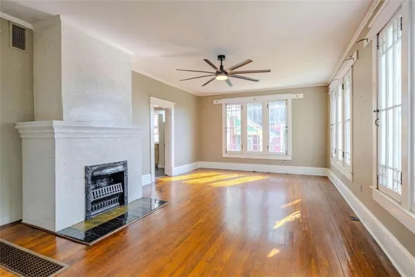a view of an empty room with a fireplace and a window
