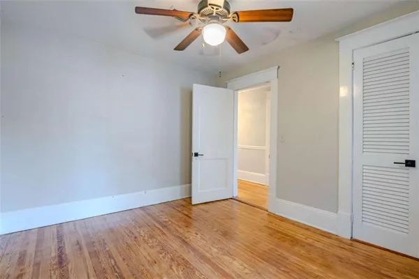 a view of a hallway with wooden floor and staircase