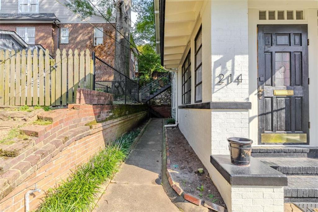 214 East 3rd Street Rome, GA 30161 - Photo 5 of 33 a view of a pathway of a house with a yard
