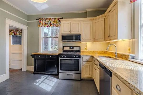 a kitchen with a sink appliances and cabinets