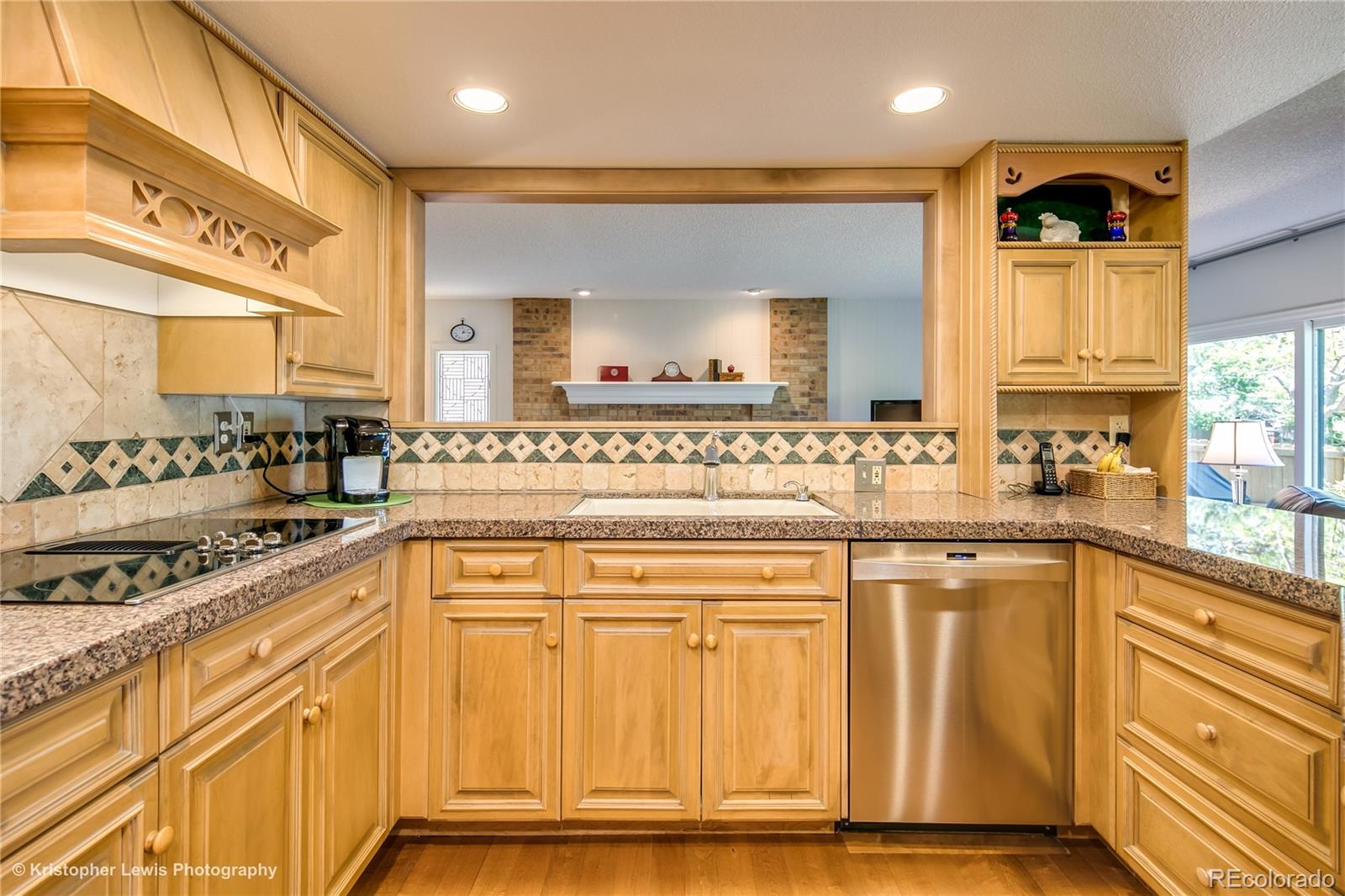 8247 Lodgepole Trail Lone Tree, CO 80124 - Photo 11 of 35 a kitchen with stainless steel appliances granite countertop a sink and cabinets